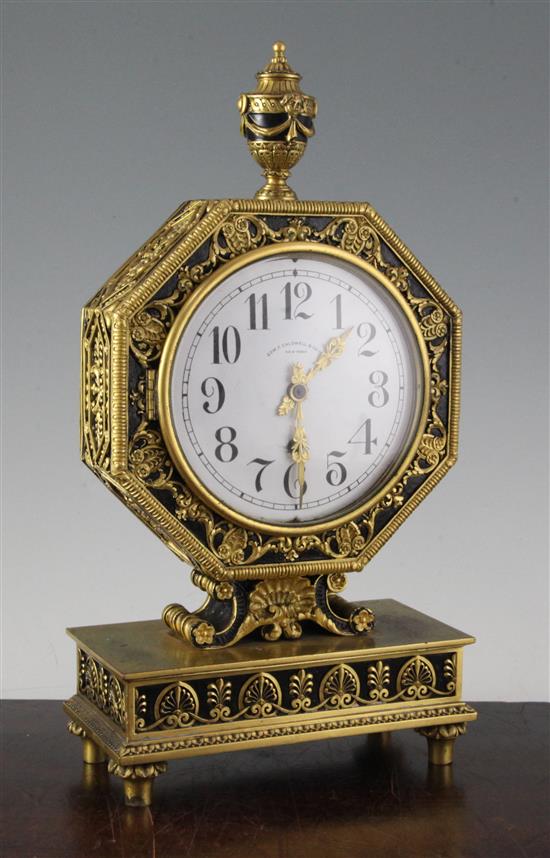 An early 20th century gilt and ebonised octagonal cased mantel clock retailed by Edward F. Caldwell & Co, New York, 13.75in.
